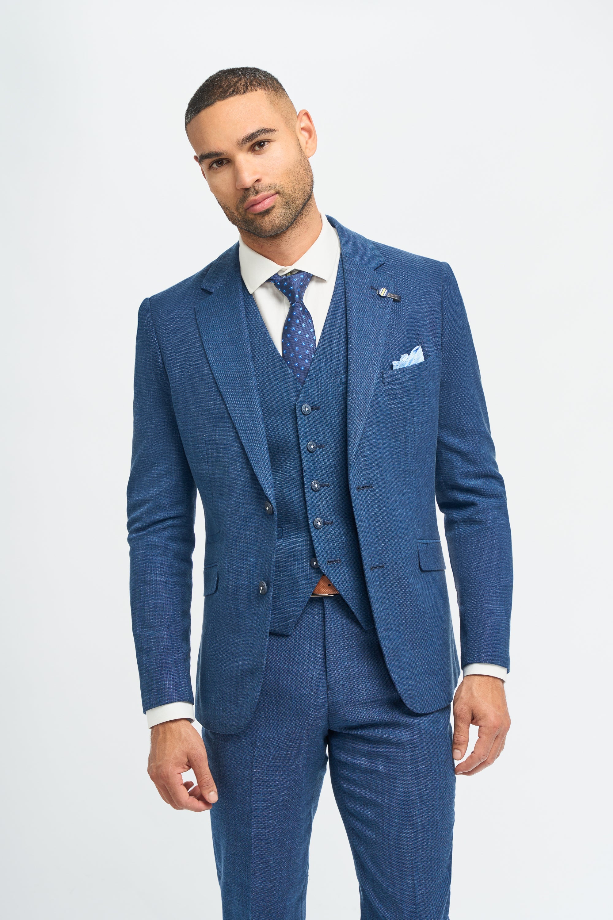 Man wearing a blue suit with a white shirt and blue tie on a white background